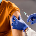 closeup healthcare worker giving vaccine senior patient