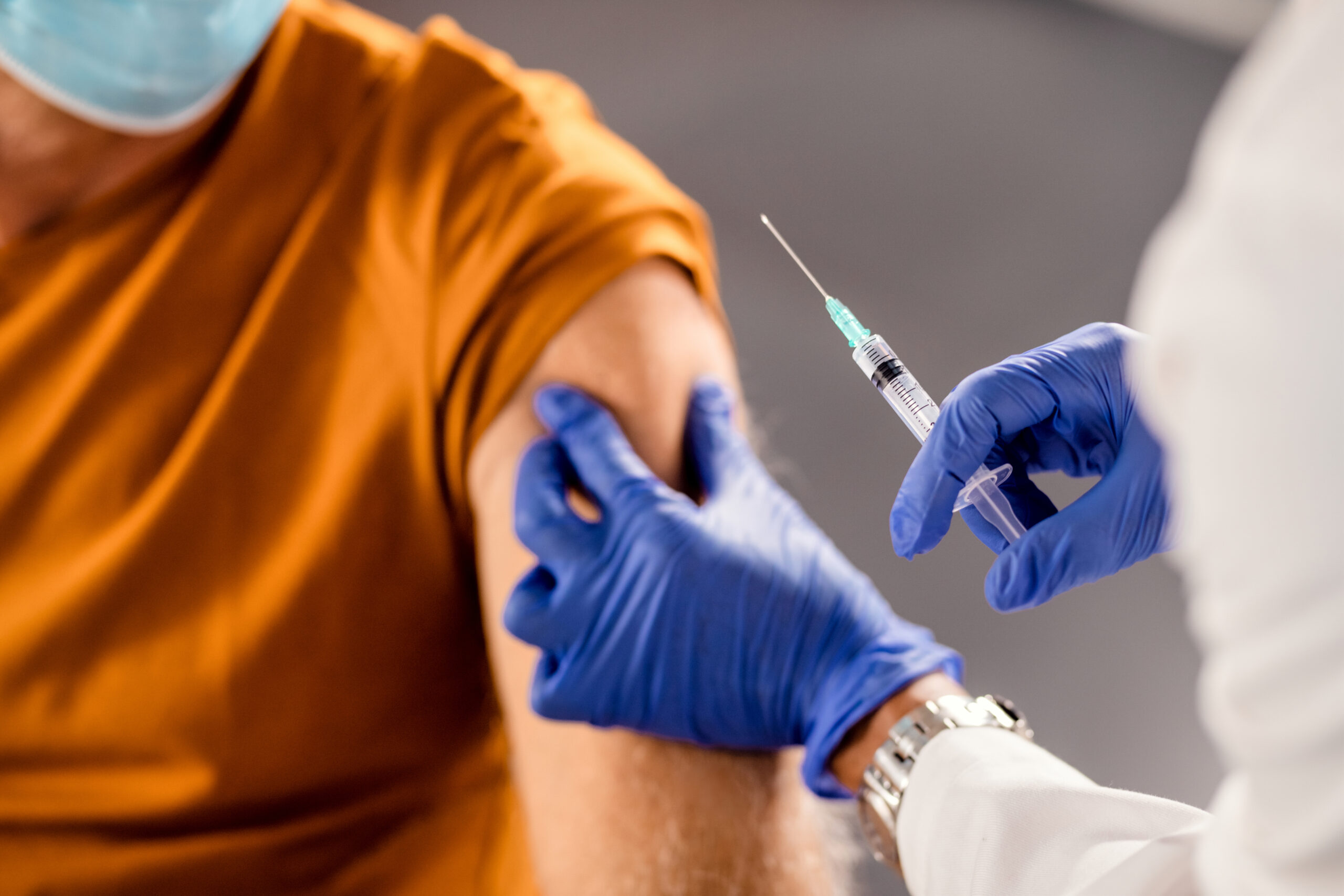 closeup healthcare worker giving vaccine senior patient scaled