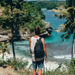 young guy with beard backpack posing jungle cap